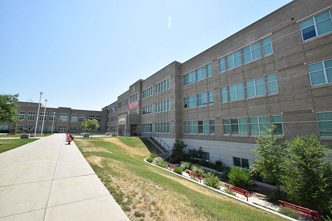 East High School East entrance and plaza with landscaping and sidewalk