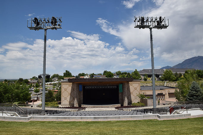 Sandy Amphitheater stage view through light towers from grass area