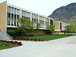 Harris Fine Arts Center from plaza with landscaping and mountains in the background