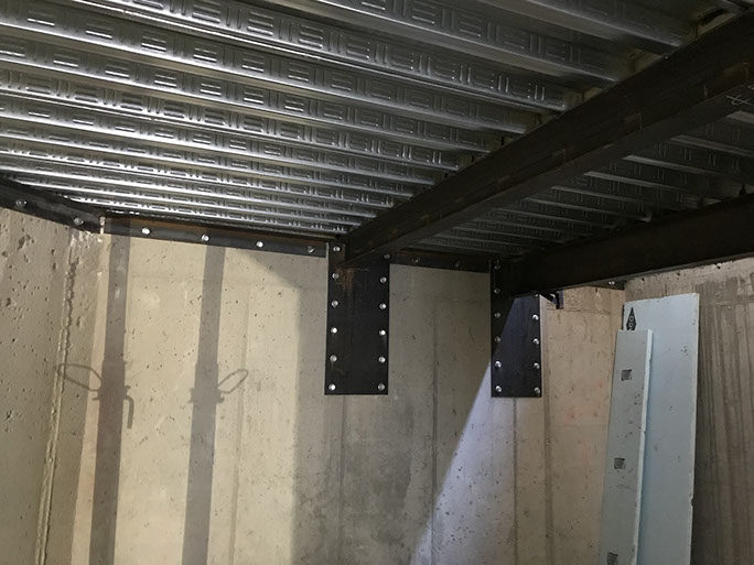 Stein Eriksen Lodge Expansion post installed plates on concrete wall with steel roof deck and framing